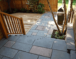 synthetic stone veneer over concrete stairs with cedar deck